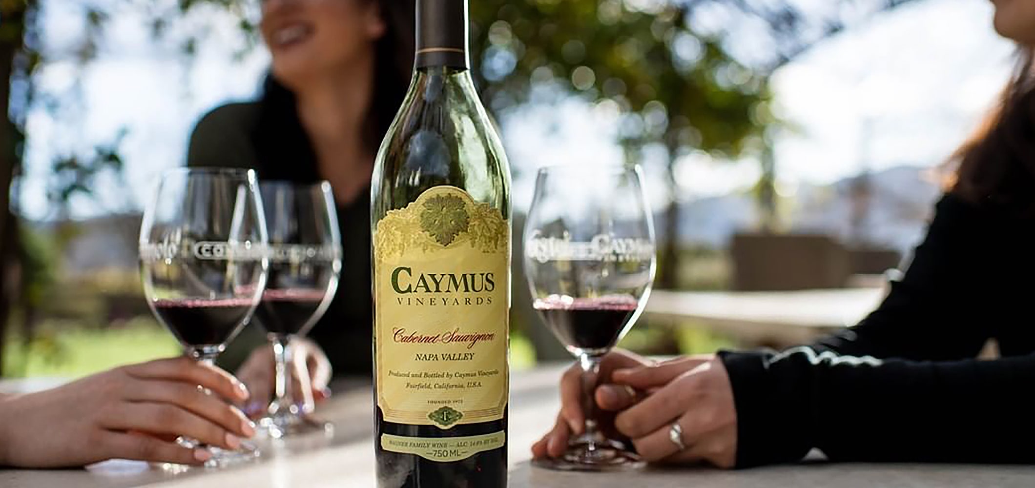 Bottle of Caymus wine and glass