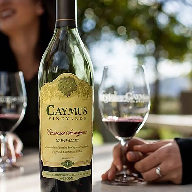 Bottle of Caymus wine and glass
